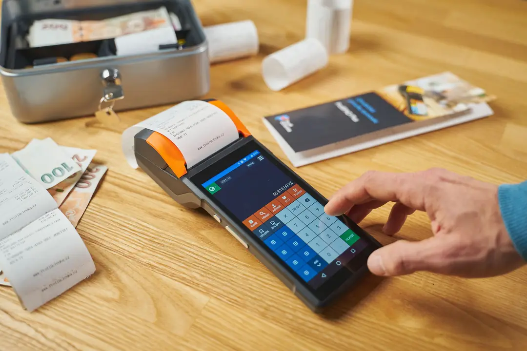 Card payment at a terminal with receipts beside it